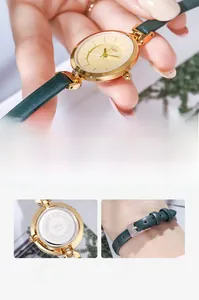 Detail view of gold-plated case with green leather strap and stainless steel back cover