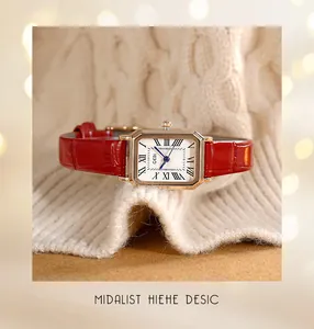 Detail of vintage rectangular quartz watch with Roman numerals and red leather strap