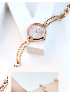 Detailed macro view of the rose gold sunray dial and镂空 metal bracelet strap on the watch