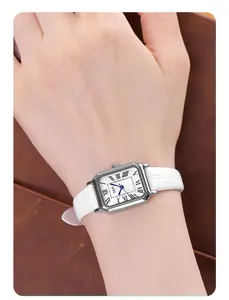 Wrist shot of a women's silver rectangular quartz watch with white crocodile leather strap