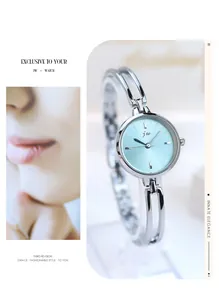 Detail of silver bangle watch with light blue sunburst dial and minimalist metal strap