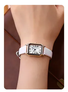Close-up of GEDI vintage square watch with rose gold case and white leather strap on wrist