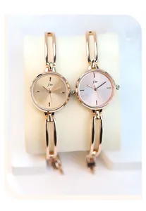 Detail of rose gold quartz watch bracelets with champagne and silver brushed dials