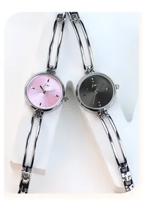Detail of silver alloy bracelet watches with pink and grey sunray dials showing the dual-rail band