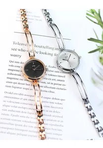 Detailed close-up of minimalist gold and silver quartz bracelet watches for women