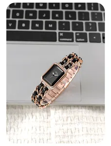 Detail of rose gold rectangular watch with woven leather and metal chain bracelet