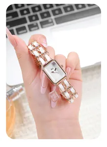 Close-up of Gedi rectangular rose gold watch with woven metal chain bracelet strap