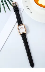 Detail view of the elegant rectangular rose gold watch with black leather lizard strap