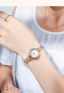 Elegant rose gold quartz watch with rhinestone bezel and roman numeral dial on wrist