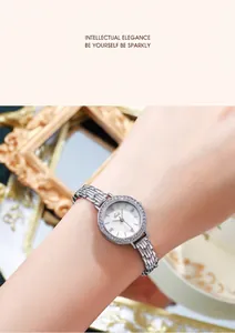 Detailed macro view of the silver alloy watch band and the rhinestone-encrusted round bezel