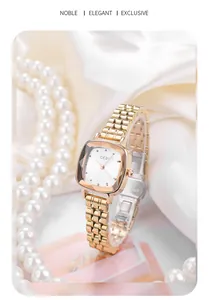 Detail of rose gold square watch for women with metal chain strap on silk and pearls