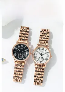 Detail of rose gold ladies watches with Roman numerals and functional calendar window