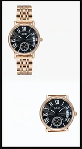 Detail of rose gold stainless steel watch with black Roman dial and calendar window