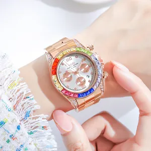 Women's rose gold watch with rainbow gem bezel and sparkling crystal accents on wrist