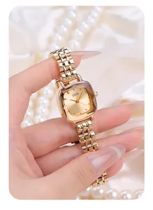 Close-up of gold square quartz watch with multi-faceted glass and five-link metal strap
