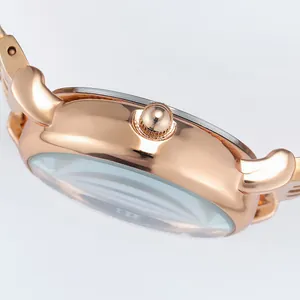 Polished rose gold stainless steel watch case side profile and textured adjustment crown
