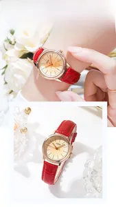 Detail of elegant women's quartz watch with red crocodile leather strap and gold dial