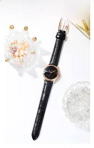 Detail of rose gold case and black leather strap on GEDI minimalist quartz watch