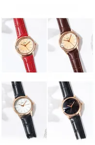 Detail of elegant quartz watches with rose gold cases and leather crocodile straps