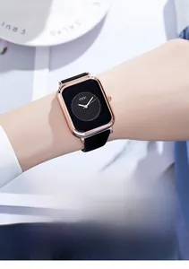 Close-up of a women's rectangular quartz watch with rose gold case and black silicone strap