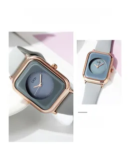 Detail of rose gold square case and soft grey silicone strap of quartz watch