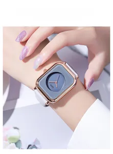 Detail view of GEDI square watch with rose gold case and white strap on female wrist