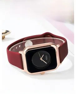 Detail of GEDI square rose gold case with black dial and burgundy silicone strap