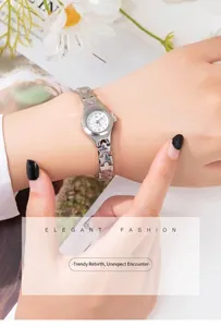 Detail of silver women's quartz watch with cross hollow chain strap and diamond markers