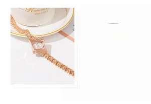 Detail of rose gold rhombus watch featuring a rhinestone bezel and chain link bracelet