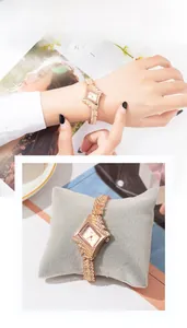 Macro shot of rose gold rhombic watch with rhinestone bezel on a velvet pillow