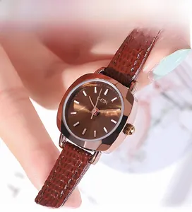 Détail macro du boîtier carré en or rose avec cadran brun et bracelet en cuir