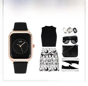 Fashionable square quartz watch styled with black outfit and accessories for women