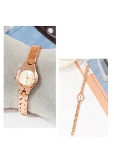 Detail of rose gold quartz watch featuring a crystal dial and a unique chain link strap