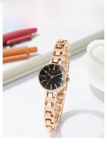 Macro view of GEDI women's rose gold mesh steel strap and minimalist black watch face