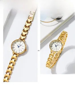 Detail view of GEDI gold stainless steel watch featuring a white dial and blue hands