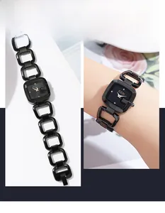 Détail d'une montre noire avec bracelet à maillons carrés évidés et fermoir à bijoux