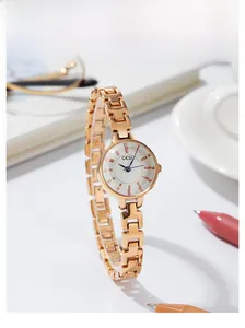 Detail view of GEDI minimalist rose gold quartz watch with a slim steel bracelet and white dial