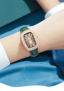 Close-up of GEDI luxury women's oval watch with diamond-set bezel and green leather strap