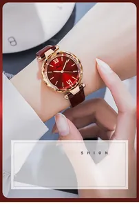 Close-up of elegant women's quartz watch with red sunray dial and gold faceted glass bezel