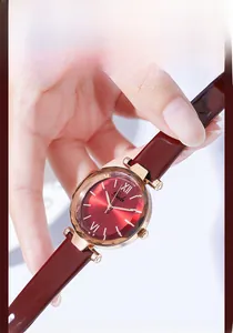 Macro shot of quartz watch with red sunray dial and diamond-cut glass mirror