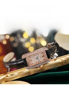 Detail of square rose gold watch with crystal encrusted dial and black leather strap