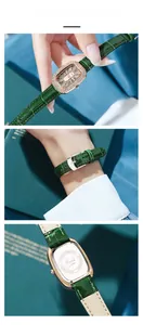 Detail of rose gold crystal watch head, green leather strap and engraved steel back