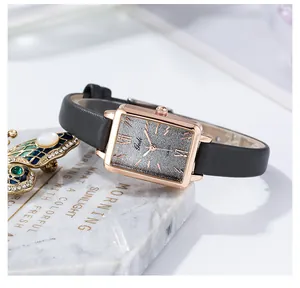 Detailed close-up of a women quartz watch with a grey gradient square dial and rose gold case