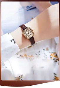 Close-up of a vintage GEDI rectangle quartz watch with brown leather croc strap on wrist