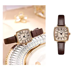 Detail of vintage square gold watch with brown leather strap and Roman numerals dial