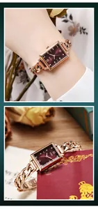 Close-up of vintage square watch with rose gold chain and red dial on model wrist