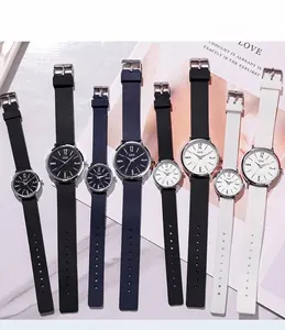 Détail de montres à quartz avec bracelets en silicone noir, bleu et blanc sur marbre