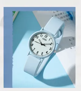 Detail view of light blue silicone strap and white dial with clear numerals for students