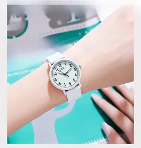 Close-up of white waterproof silicone strap and quartz watch dial for women