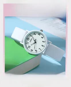 Detailed close-up of a white silicone strap quartz watch with minimalist numeral dial